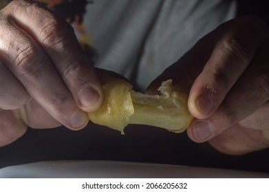 Spring Rolls On A White Brato With Hands Opening A Cheese Roll