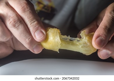 Spring Rolls On A White Brato With Hands Opening A Cheese Roll