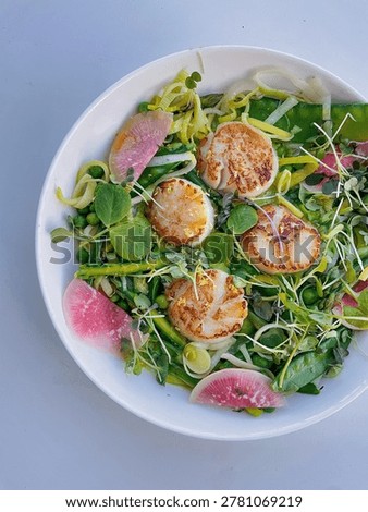 A spring salad with seared scallops