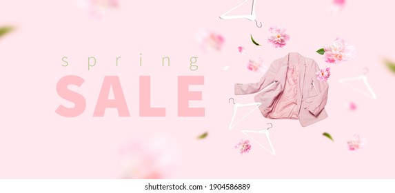 Spring Sale Springtime Discounts. Womens Fashionable Flying Pink Blazer Flowers Peonies White Wooden Hanger On Gray Background. Creative Clothing Concept Shopping. Female Stylish Fabric Cotton Jacket