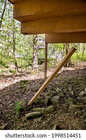 Spring Season In Blue Ridge Mountains Ski Resort Town With Closeup Of House Home Building Stilts Broken From Storm Or Earthquake That Can Lead To Danger Of House Falling Down