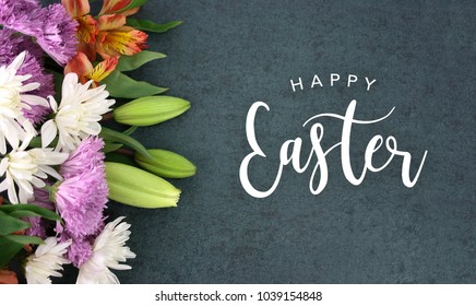 Spring Season Still Life With Happy Easter Calligraphy Holiday Script Over Dark Blackboard Background Texture With Beautiful Colorful White, Pink, Orange, Purple And Green Flower Blossom Bouquet