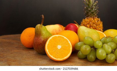 Spring or Summer concept. Many kinds of fruit lying on wooden table, can use for summer or food content background. Orange, apple, pineapple