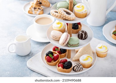 Spring Or Summer Dessert Table, Three Tiered Tray With Variety Of Desserts And Sandwiches For Tea