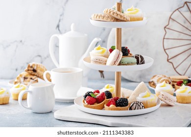 Spring Or Summer Dessert Table, Three Tiered Tray With Variety Of Desserts And Sandwiches For Tea