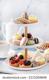 Spring Or Summer Dessert Table, Three Tiered Tray With Variety Of Desserts And Sandwiches For Tea