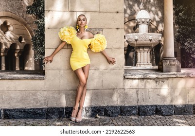 Spring, Summer Fashion. High Fashion Model. Glamour, Stylish Elegant Woman. Female Model In Amazing Yellow Dress In The City. Travel Model. Outdoor Shoot. Elegance. Vogue.