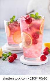 Spring or summer refreshing cold cocktail or mocktail with berries and lemon, raspberry lemonade - Shutterstock ID 2109490610