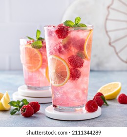 Spring or summer refreshing cold cocktail or mocktail with berries and lemon, raspberry lemonade - Shutterstock ID 2111344289