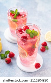 Spring or summer refreshing cold cocktail or mocktail with berries and lemon, raspberry lemonade