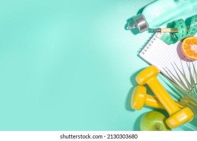 Spring, Summer Slimming Season Concept. Sport Bottle With Water, Fitness Dumbbells, Beach Lounger Decor, Measuring Tape, Notepad, Apple, Sliced Orange On Light Blue White Background. Flatlay