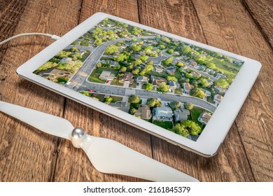 Spring Sunrise Over Residential Area Of Fort Collins In Northern Colorado With Streets After Asphalt Crack Sealing, Reviewing Aerial Image On A Tablet