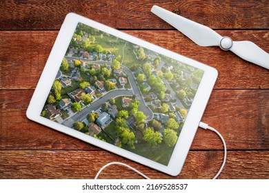 Spring Sunrise Over Residential Area Of Fort Collins In Northern Colorado With Streets After Asphalt Crack Sealing, Reviewing An Aerial Image On A Digital Tablet, Screen Picture Shot By Myself