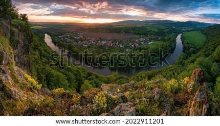 Spring sunset over meander of river Hron in Slovakia from extinct volcano, biotope of rare plants and flowers. Discover the spring beauty of the mountains and rivers.