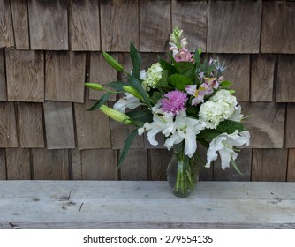 Spring Table Bouquet At A Wedding On Valentine's Day In The French Countryside --floral Arrangement Contains Casablanca Lilies, Hydrangea, Dianthus, Snapdragon Flowers, Purple And Pink Mums, And More.