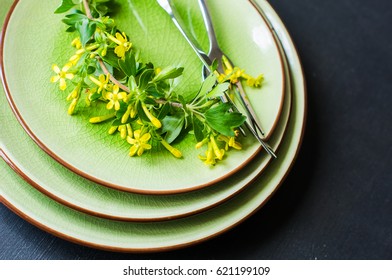 Spring table setting with blooming tree branch with  yellow flowers