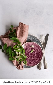 Spring table setting decorated with fresh Acacia flowers on conc