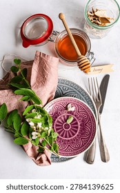 Spring table setting decorated with fresh Acacia flowers on conc