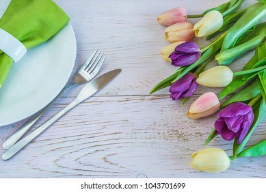 Spring Table Setting With Purple And Pink Tulips