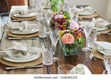 Spring Tablescape set for Easter Dinner with bunnies, pottery barn napkins and RH table and chairs.