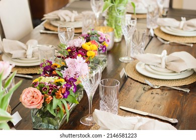 Spring Tablescape set for Easter Dinner with bunnies, pottery barn napkins and RH table and chairs.