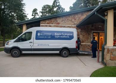 Spring, Texas / USA - August 12th, 2020: Gulf Coast Regional Blood Center Van Parked At A Donation Center. Workers Unloading Vehicle During Coronavirus Pandemic.