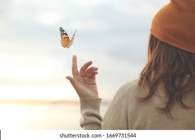 spring time, a butterfly leans delicately on a woman's hand