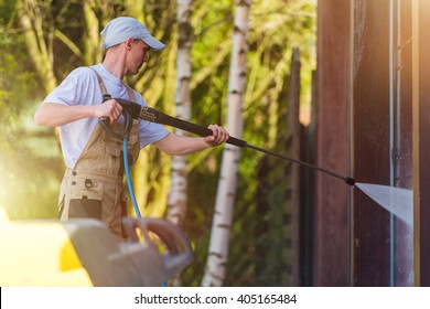 Spring Time House Walls Cleaning By High Pressure Water Spraying. Caucasian Men At Work.