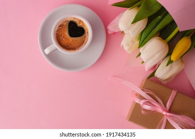 Spring Tulip Flowers, Gift Box And Coffee Cup On Pink Table From Above In Flat Lay Style. Greeting For Womens Or Mothers Day. 8 March Day