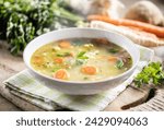 Spring vegetable soup with chopped and grated root vegetables, seasoned with yeast. Healthy vegetable vegetarian food.