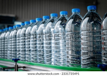 Spring Water factory - Selective focus of Water bottling line for processing pure water into small bottles. 