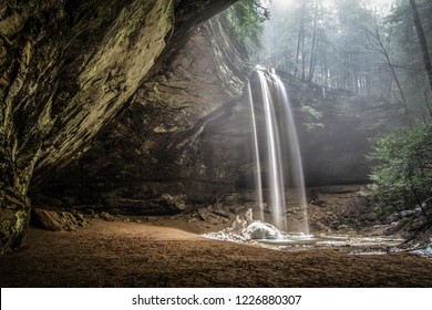 Spring Waterfall Nature Landscape. Spring waterfall flows over the edge into Ash Cave in Hocking Hills State Park in southeastern Ohio.