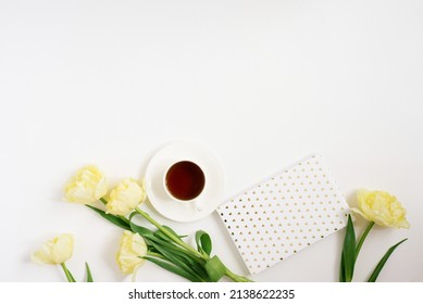 Spring Yellow Tulips, Coffee Mug, Notebook On A White Background. Flat Position, Top View.