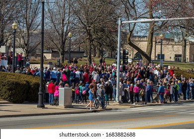 Springfield, IL / USA - March 8th 2020: Large Crowd Of People Gathered At A Women's Rights Rally Held In The State Capital. The Crowd Listens To Each Speaker Before Finally Beginning To March.  