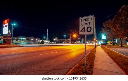 Springfield, Missouri - June 2017: Night Shot In The City Birthplace Of Route 66 The Most Famous Road. Speed Limit Sign And Lights In A Motel