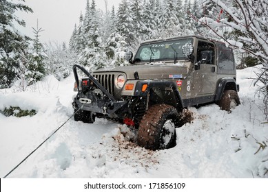 SPRINGHILL, NOVA SCOTIA - JANUARY 9, 2011 - Jeep Stuck In Snow Uses Winch For Self-recovery.