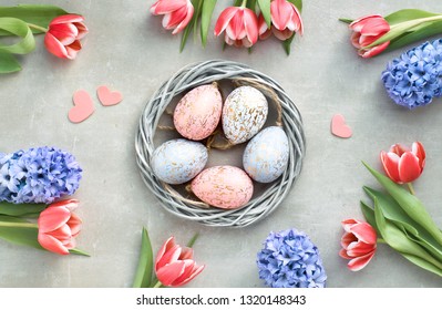 Springtime Flat Lay With Easter Eggs In Wattle Wreath, Pink Tulips And Blue Hyacinth, Space For Your Text