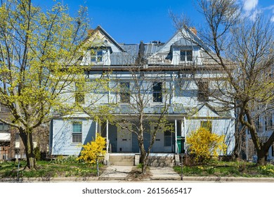 Springtime view of a charming duplex house with dormers in Brighton, Boston, Massachusetts, USA