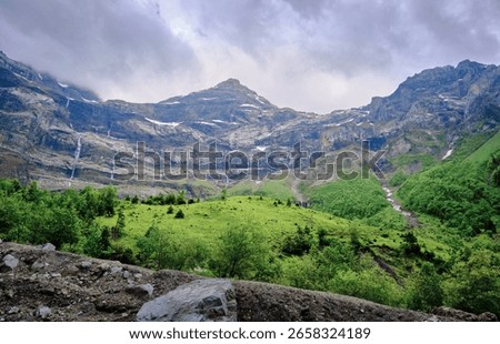 Springtime waterfalls cascade surrounded by lush alpine landscapes and cliffs, Swiss Alps, Creux de Champ, Les Diablerets, Switzerland.