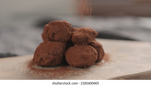 Sprinkle Cocoa Powder Over Handmade Chocolate Truffles On A Wood Board, Wide Photo