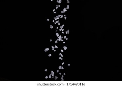 Sprinkle Salt For Seasoning On A Black Background