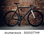 Sprint carbon bicycle with one fixed gear. The wall from a brick background.