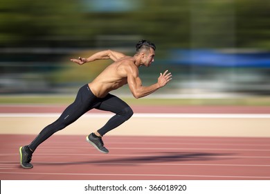 Sprinter leaving  on the running track. Explosive start. - Shutterstock ID 366018920