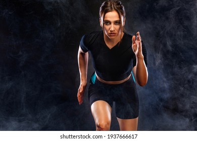 Sprinter and runner girl. Running concept. Woman running on the black background. The concept of a healthy lifestyle and sport. Woman in sportswear.