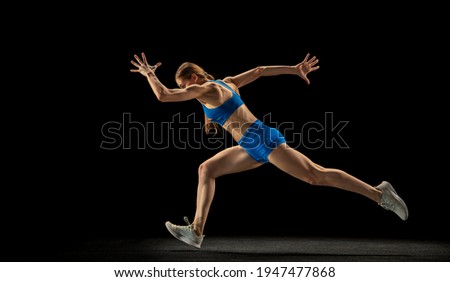 Similar – One young middle age athletic, woman training, exercising with fitness jumping rope over dark background, full length front view, looking at camera