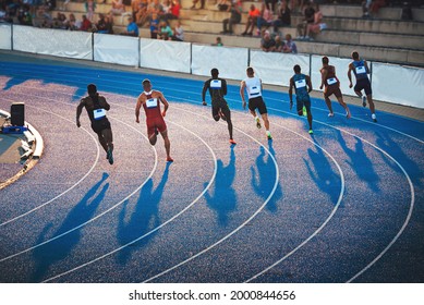 Sprinter, die auf der Leichtathletikbahn bei Sonnenuntergang laufen. Shadows on the track, Sprint, Track and Field foto, Original-Wallpaper für Spiele in Japan, Tokio. Athletiktreffen auf blauem Weg
