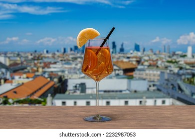 Spritz cocktail on a table with view of Milan, Italy