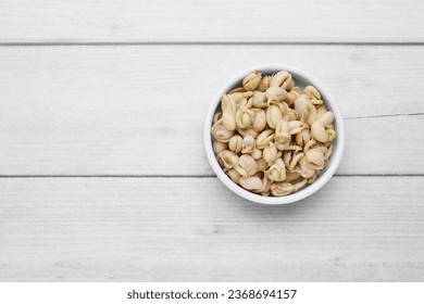 Sprouted kidney beans in bowl on white wooden table, top view. Space for text - Shutterstock ID 2368694157
