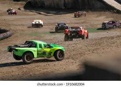 Spruce Grove, Alberta - Canada - August 29 2020: A Group Of Trophy Trucks Seen Taking The First Turn Of A Race Together