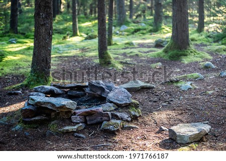 Spruce Knob area with Huckleberry trail and stone rocks fire pit firepit for backpacking camping in pine spruce forest in fall with dark landscape in West Virginia